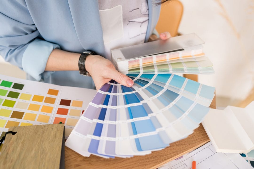 close up of architect woman choosing samples of wall paint